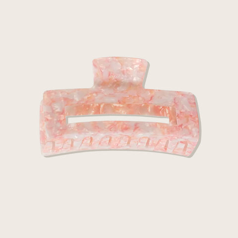 Pince à griffe rose Pixie Woo pour cheveux, avec dents fines pour démêler et coiffer.