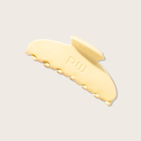 Pince demi-lune banana bread jaune de la marque Pixie Woo pour cheveux, en forme de banane, coloris jaune.