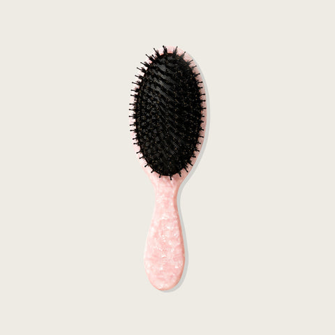 Brosse à cheveux Pixie Woo pour la brillance, design ergonomique en plastique, idéale pour démêler et lisser les cheveux.