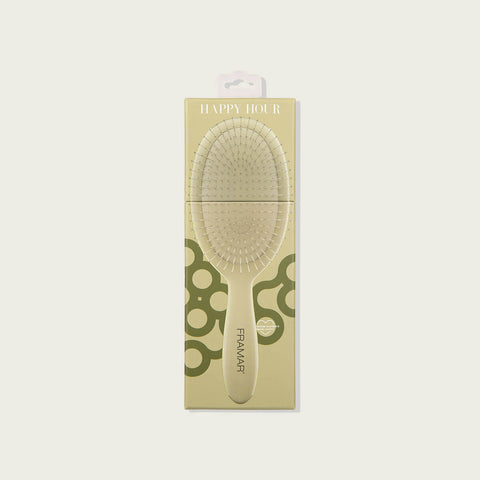 Brosse démêlante Framar Happy Hour pour cheveux, outil de coiffure avec poils souples en plastique blanc et rose pâle.