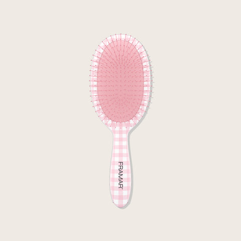 Brosse démêlante Framar en tissu à carreaux rose, design professionnel pour démêler en douceur les cheveux.