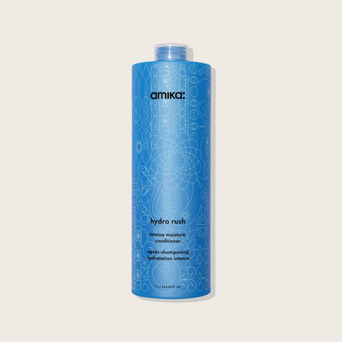 Revitalisant hydratant Amika Hydro Rush pour cheveux, bouteille blanche avec pompe et logo coloré, vue de face.