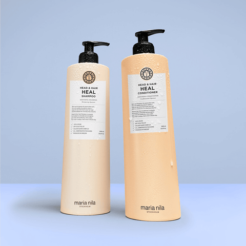 Revitalisant apaisant Maria Nila Head & Hair Heal pour cheveux, texture crémeuse et flacon blanc avec logo noir.