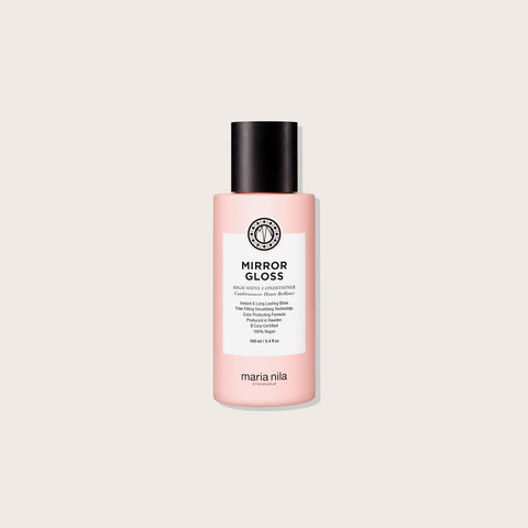 Revitalisant haute brillance Maria Nila Mirror Gloss pour cheveux, flacon avec pompe et texture lisse.