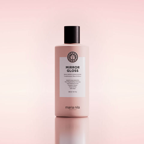 Revitalisant haute brillance Maria Nila Mirror Gloss pour cheveux, flacon élégant avec étiquette colorée et texte.