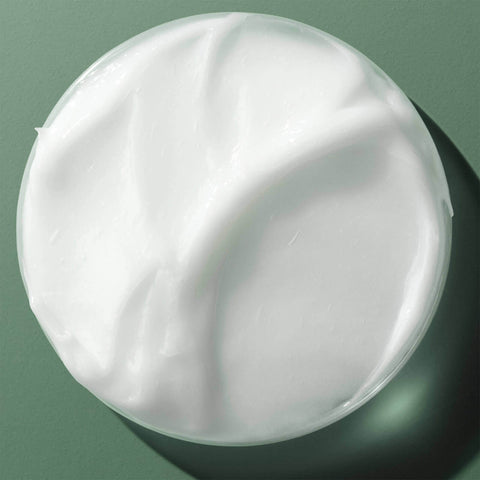 Revitalisant réparant Biolage Strength Recovery pour cheveux, texture crémeuse et application sur cheveux mouillés.