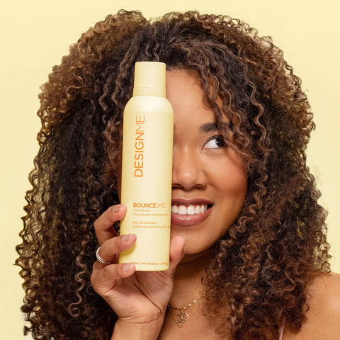 Mousse boucles Design.Me BOUNCE.ME pour cheveux, texture légère et volumisante, flacon avec embout spray.
