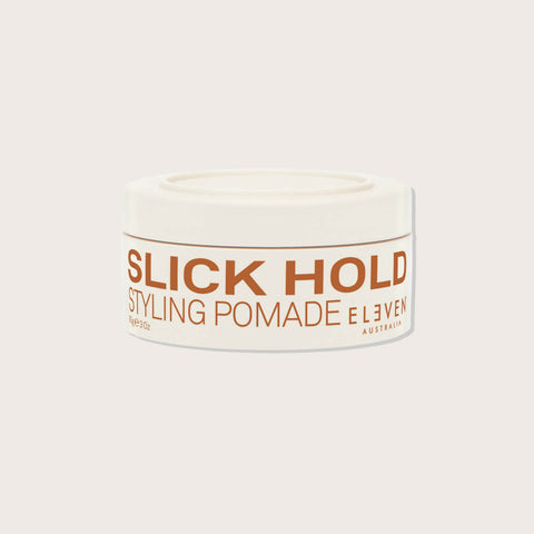 Pommade coiffante ELEVEN AUSTRALIA Slick Hold 85 ml pour cheveux, texture brillante et fixation forte, dans un flacon blanc.