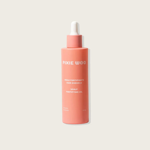 Huile fortifiante pour cuir chevelu de la marque Pixie Woo, flacon d'huile capillaire naturel et apaisant.