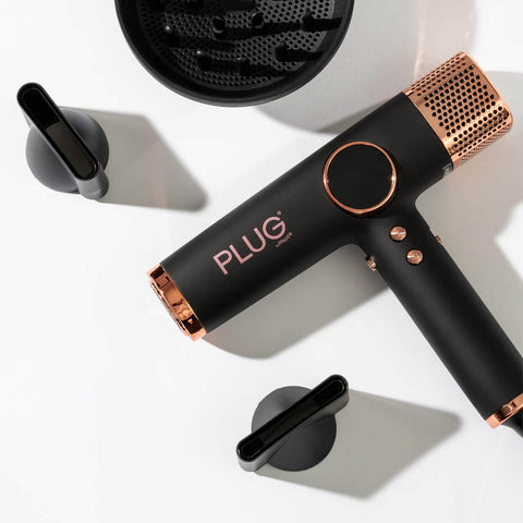 Séchoir à air noir Plug By Must52, outil de séchage portable avec design compact et poignée ergonomique.