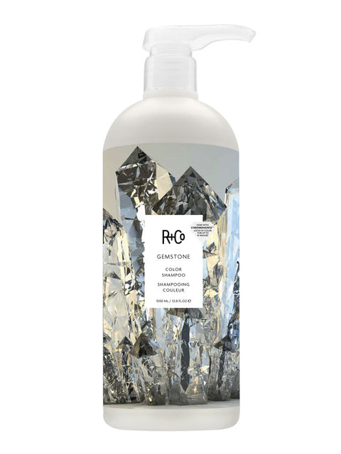 Shampooing couleur gemstone de R+Co pour cheveux, bouteille élégante avec étiquette colorée, visible sur l'image.
