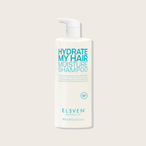Shampooing hydratant pour cheveux de la marque Eleven Australia, bouteille blanche avec étiquette colorée, vue de face.