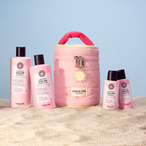 Trousse de beauté Maria Nila Luminous Colour pour cheveux, contenant des produits capillaires dans une pochette élégante.
